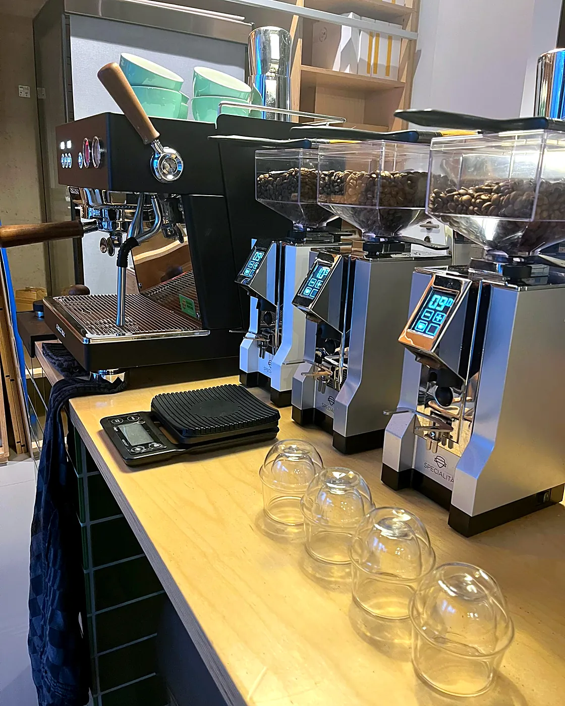 Grinders and cupping glasses on the atelier bar